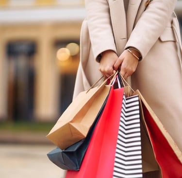 a woman holding shopping bags in her hand
