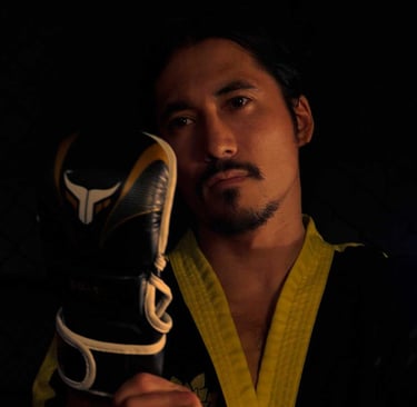 a man in a marcial arts uniform holding a pair of gloves