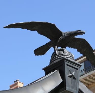 Eagle Gate, a statue of a bald eagle with wings spread atop a beehive