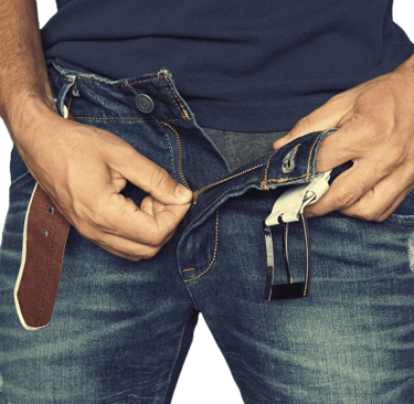 Front view photo of a light skinned man unzipping his jeans