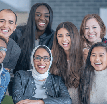 a diverse group of students standing around a table