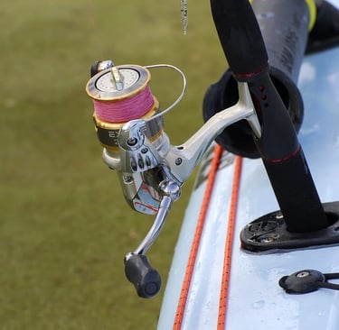 a fishing reel with pink fishing line