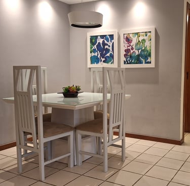 a dining room table with chairs and a lamp