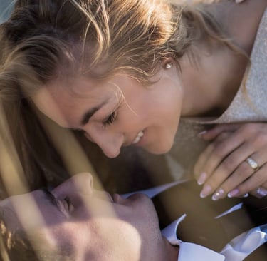 a man and woman laying on the ground