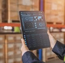 a man in a warehouse with a tablet computer and a tablet