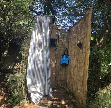bamboo constructed outdoor shower set in woodland