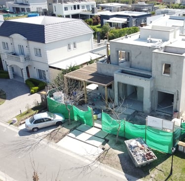 a house with a green tarp and a car parked in front of it