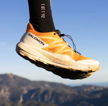 a person's feet in the air with a pair of socks on