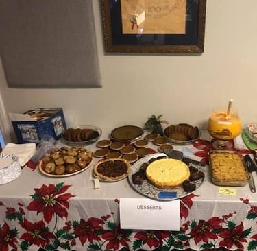 A dessert table spread on a poinsettia tablecloth