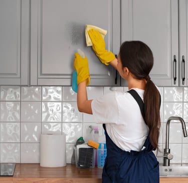 House cleaning expert from KLEAN WELL removes grease from kitchen cabinets for a spotless finish