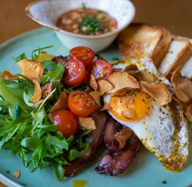 a plate of food with breaded bread and a bowl of soup