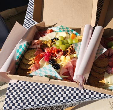 a box of food in a box with a checkered table cloth