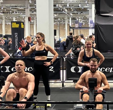Arena shot – bright lights, crowds, athletes rowing