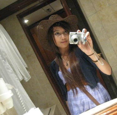 Highschooler Ari taking a mirror selfie with the silver Olympus.