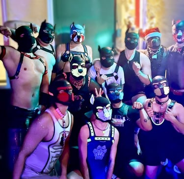 A group of men in pup masks posing together in a club