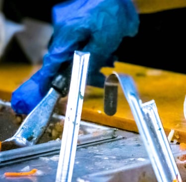 a person in gloves and gloves holding a knife and fork