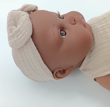 Minikane doll Augustine wearing headband