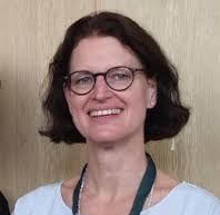 a woman in glasses and a white shirt