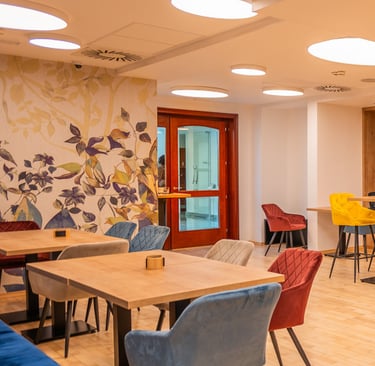 a room with a table and chairs and a clock