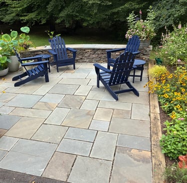 Backyard patio with stacked stone retaining wall