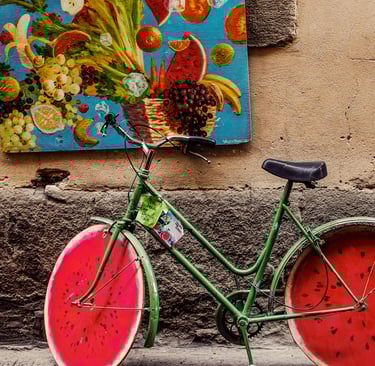 a green bicycle with a watermelon painted wheels