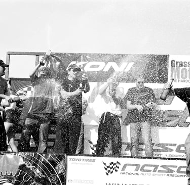 Jason Friday pops champagne on podium