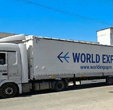 a truck with a world of expo pro truck parked in front of a building