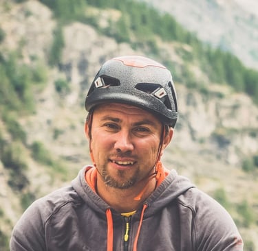 a man in a helmet on a mountain