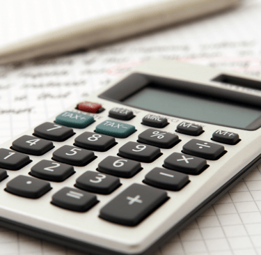 a tax calculator with a pen and a pen