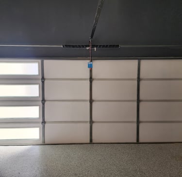 Installed insulation on garage door for temperature control by On Point Overhead doors