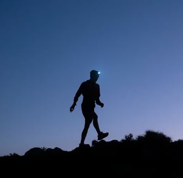 a person walking on a hill with a blue sky in the background