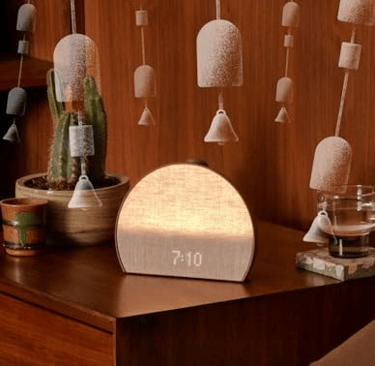 Hatch Restore 3 sunrise alarm clock with glowing light.