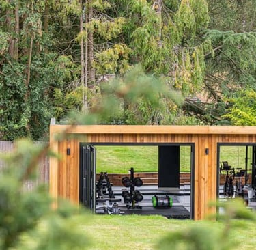 a wooden garden pod gym with fitness equipment