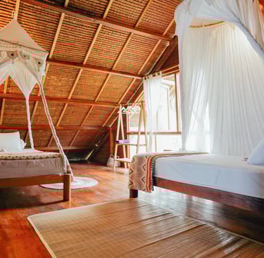 Cozy double bedroom in Toska Surf House with canopy bed and wooden interiors