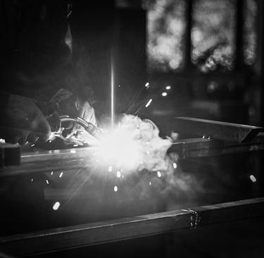 a person welding a metal object in a dark room
