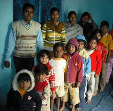 a group of people standing in front of a blue wall
