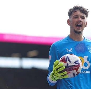a soccer player is holding a soccer ball