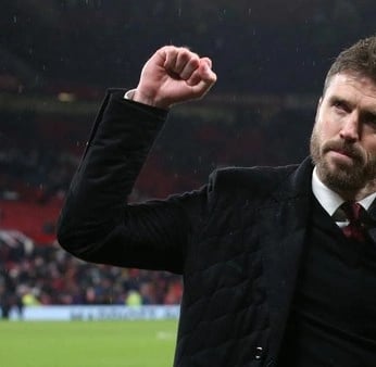 a man in a suit and tie is holding a fist