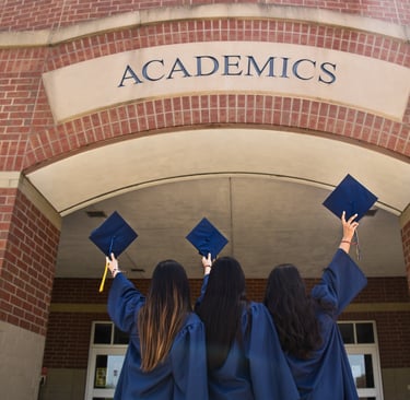 Three graduates in blue caps celebrating academic success under the label 'ACADEMICS'