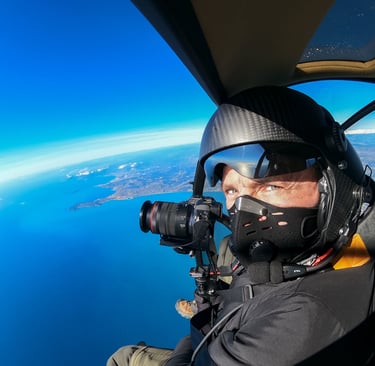 a man in a helmet and goggles is taking a picture of a man in