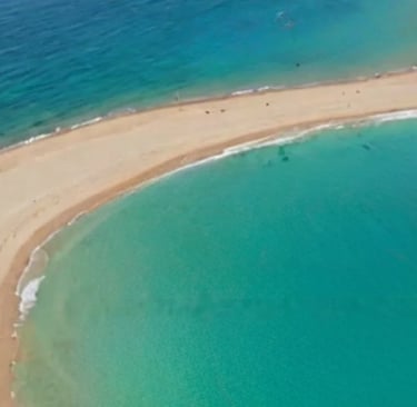 a beach with a sandy beach in prasonisi