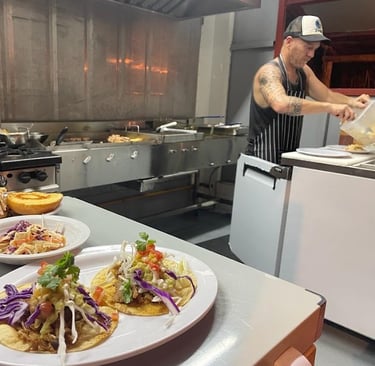 Fresh tacos, pulled pork sandwich and cole slaw. Barrel Bar & Grill restaurant kitchen.