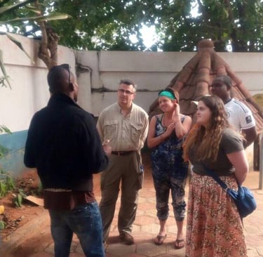 Dahomey African Tours Guide leading tourists in Pythons Temple in Benin