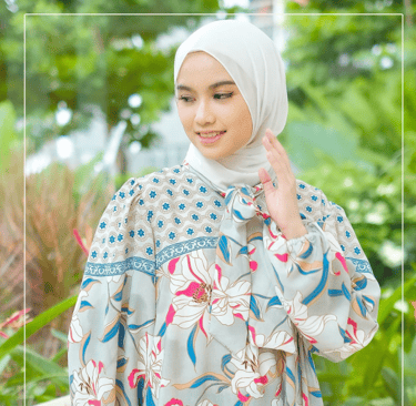 a woman in a floral dress with a hijab