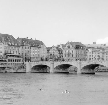 a bridge spanning over a river with several people