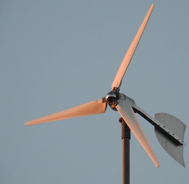 a wind turbine on a pole with a blue sky in the background