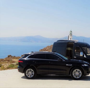 a van parked on a hill with a lighthouse in the background
