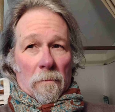 a man with a beard and a scarf around his neck