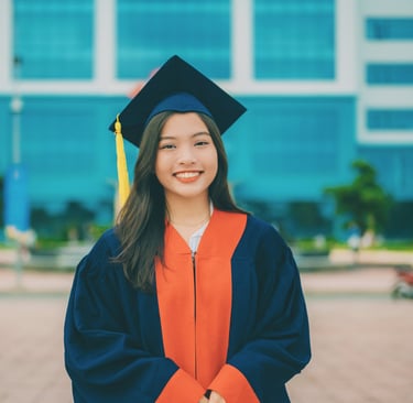 young woman dressed in graduation cap and gown heading into a life transition