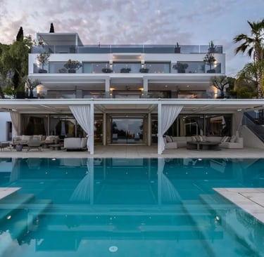 Villa Serenity poolside view with white façade and terraces